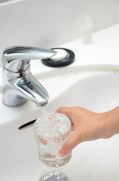 istock Filling a glass with water under the tap 833844668