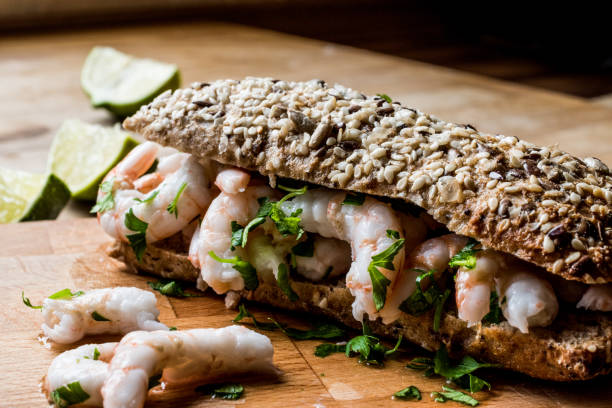 istock Shrimp Sandwich with lime on wooden surface. 833844994