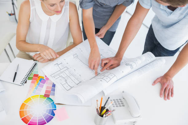 istock High angle view mid section of artists working on designs 833851880