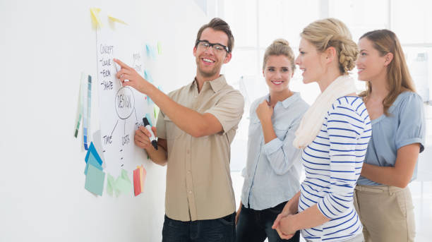 istock Artists in discussion in front of whiteboard 833853326