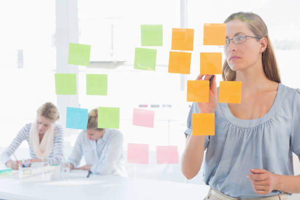istock Concentrated artist looking at colorful sticky notes 833854824