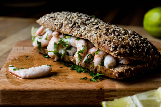istock Shrimp Sandwich with lime on wooden surface. 833857300