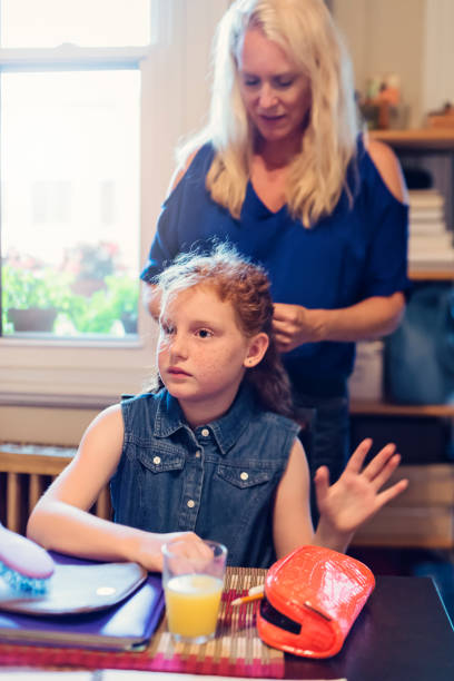 istock Young redhead girl getting ready on school morning. 833897198