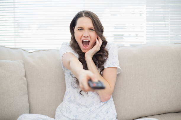 istock Scared young woman changing tv station 833899790