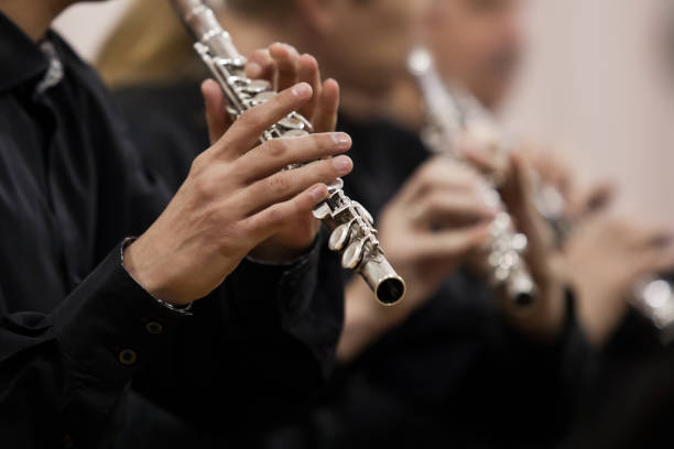 Hands musician playing the flute Hands musician playing the flute in the orchestra closeup classical-music stock pictures, royalty-free photos & images