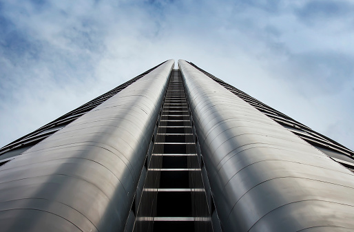 Perspective view of skyscraper exterior over sky background
