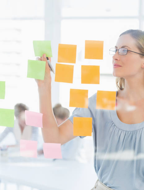 istock Concentrated artist looking at colorful sticky notes 833933510