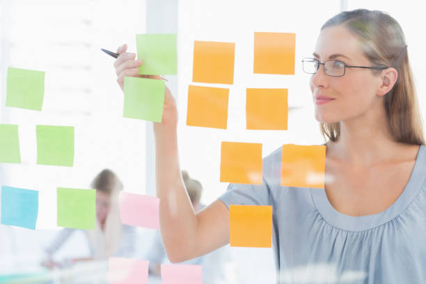 istock Concentrated artist looking at colorful sticky notes 833933526