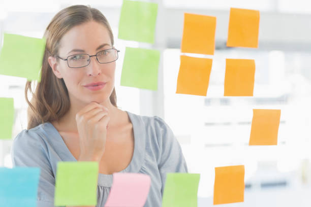 istock Concentrated artist looking at colorful sticky notes 833933820