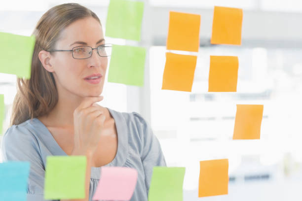 istock Concentrated artist looking at colorful sticky notes 833933874