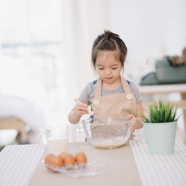 istock Little girl baking in the kitchen 833938090