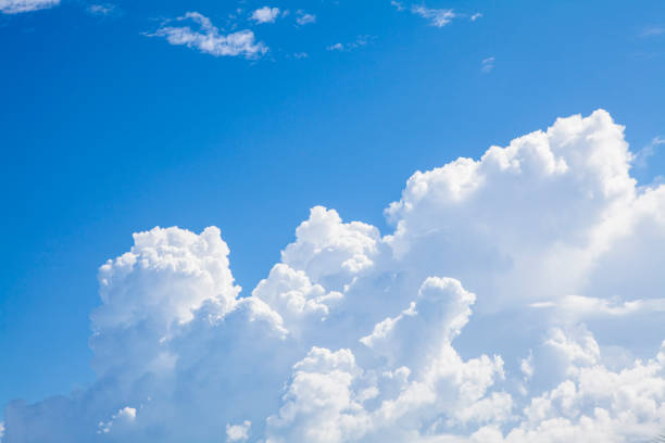 istock White fluffy clouds in the blue sky. 833938826