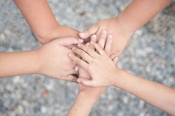 close up of many hands in circle - child connection; teamwork together with Spirit concept. stock photo