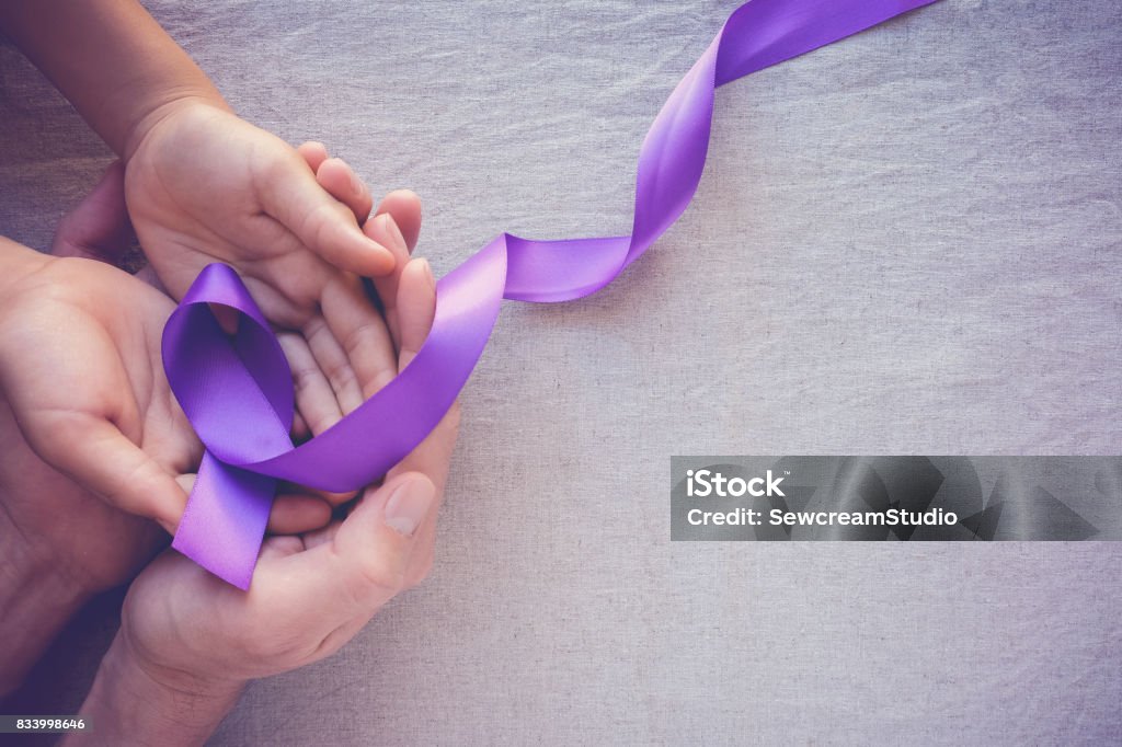 Hands holding Purple ribbons, toning copy space background, Alzheimer disease, Pancreatic cancer, Epilepsy awareness, domestic violence wareness Ribbon - Sewing Item Stock Photo