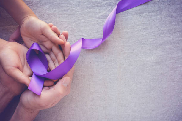 hands holding purple ribbons, toning copy space background, alzheimer disease, pancreatic cancer, epilepsy awareness, domestic violence wareness - domestic issues imagens e fotografias de stock