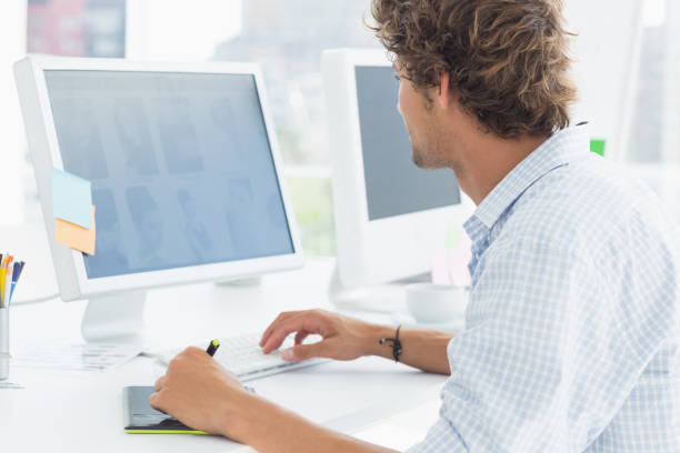 istock artist drawing something on graphic tablet with pen 834022434