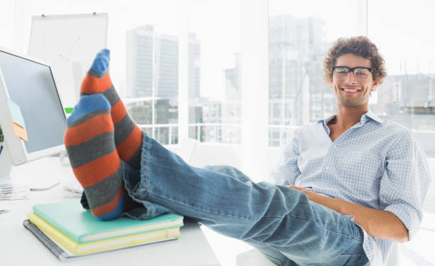 istock Relaxed casual man with legs on desk in office 834022772
