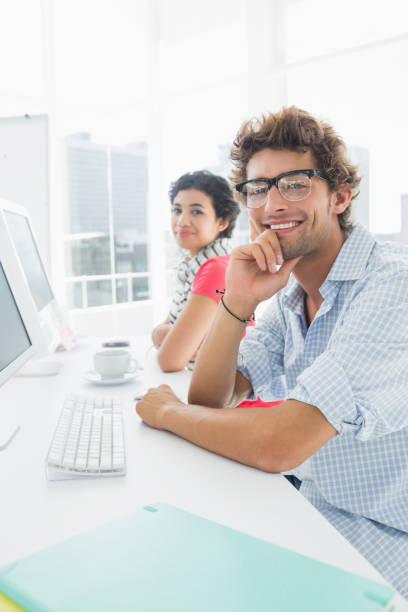 istock Smiling casual couple at desk in office 834023012
