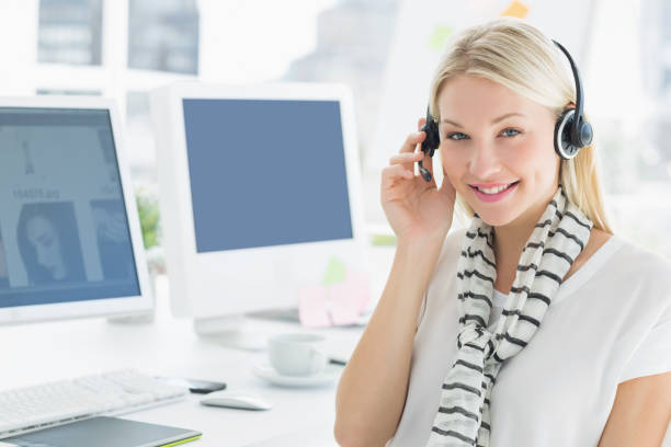 istock Smiling casual young woman with headset in office 834035232