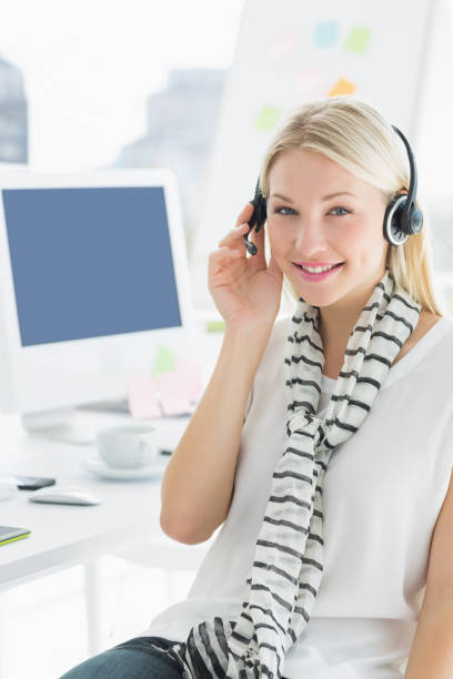 istock Smiling casual woman with headset in office 834035324