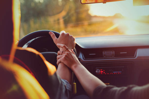 istock Couple driving car on way to sunset 834060052