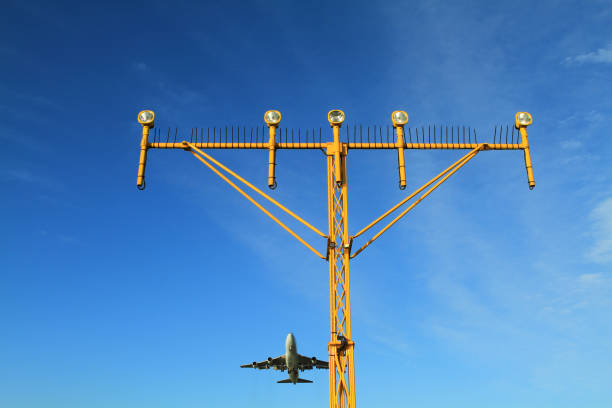 istock Airport landing lights with airplane approaching runway lighting 834070028