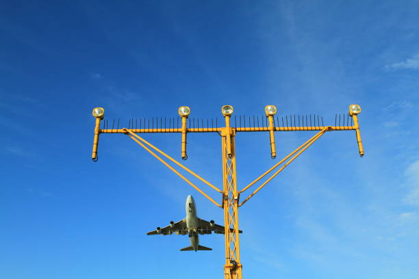 istock Airport landing lights with airplane approaching runway lighting 834070076