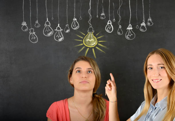istock Two women and big idea light bulb 834086454