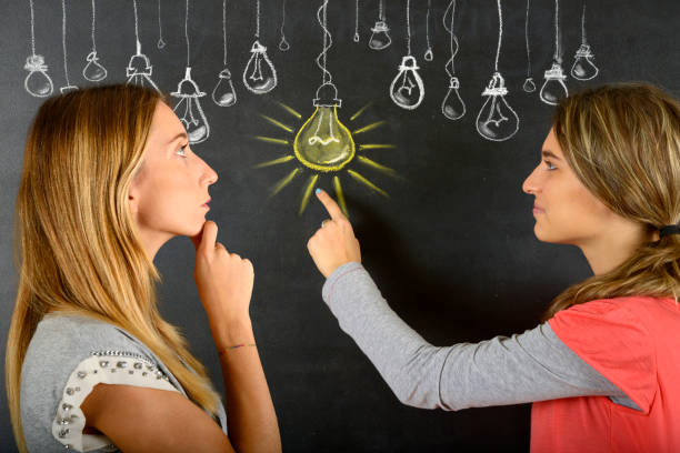 istock Two women and big idea light bulb 834086968