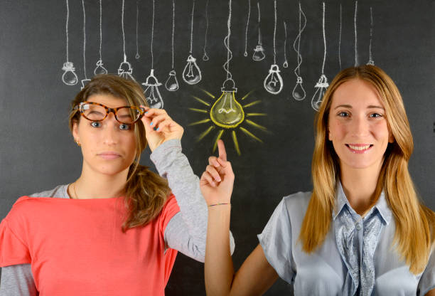 istock Two women and big idea light bulb 834087592