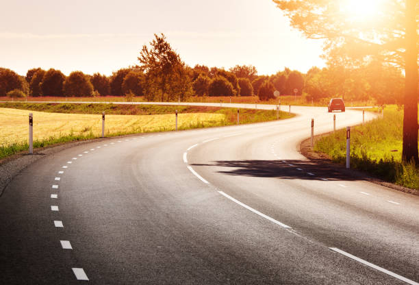 Road panorama on sunny spring evening asphalt road view in countryside at beautiful sunset country road stock pictures, royalty-free photos & images