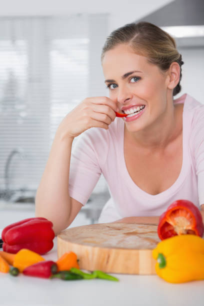 istock Attractive woman posing while eating vegetables 834124102
