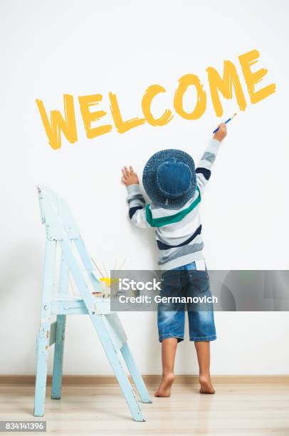 Happy Child Paints With Paint Stock Photo - Download Image Now - Welcome Sign, Greeting, Child