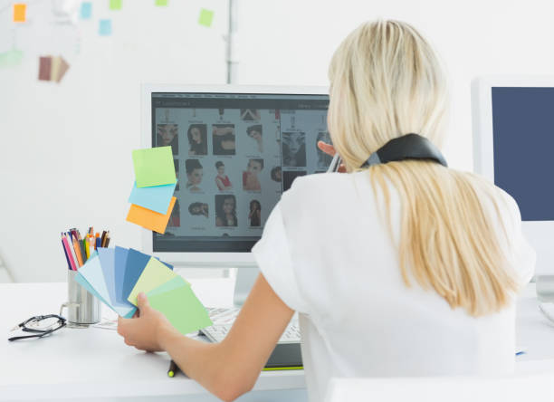 istock Rear view of a casual woman using computer in office 834146856
