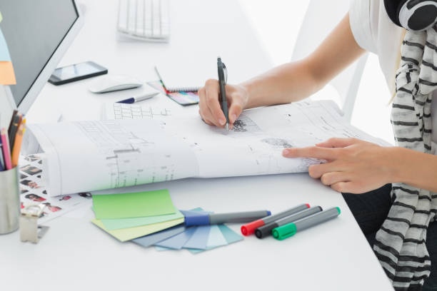 istock Artist drawing something on paper with pen at office 834146892