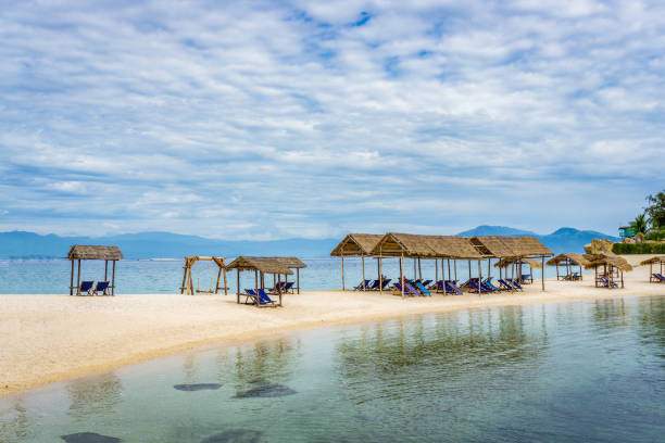istock Lounge chairs under tent on beach 834151246