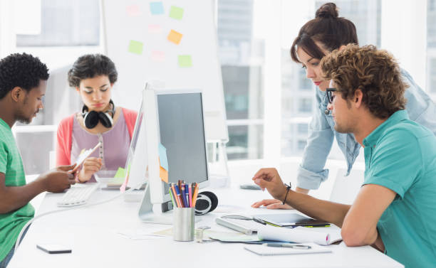 istock Artists working at desk in creative office 834151556