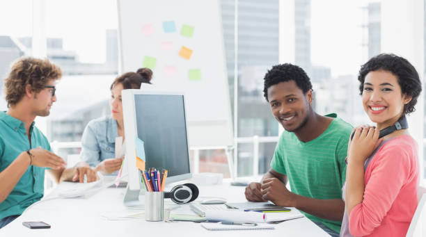 istock Artists working at desk in creative office 834151606