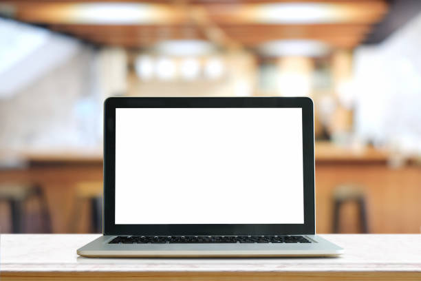 istock Mock up Blank screen of Laptop on marble table in Co-working or cafe. 834157812
