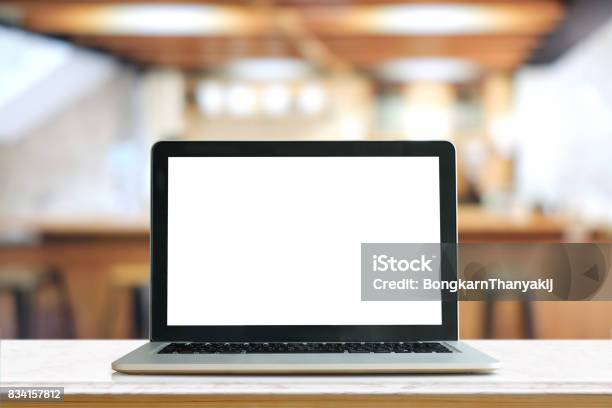 Mock Up Blank Screen Of Laptop On Marble Table In Coworking Or Cafe Stock Photo - Download Image Now