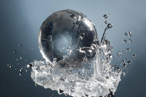 istock glass globe planet in drop water splash on blue background 834158342