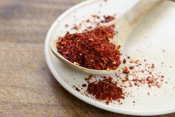 istock Spices paprika in a wooden spoon on a table 834161422