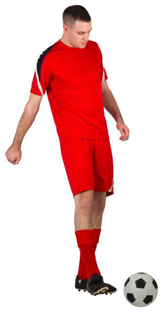 istock Fit football player playing with ball 834176510