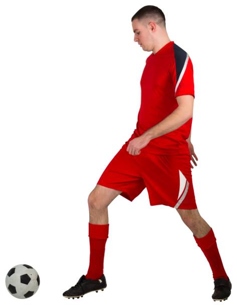 istock Fit football player playing with ball 834176652