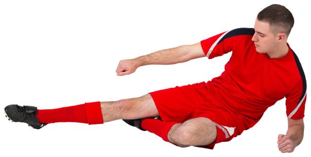 istock Fit football player playing and kicking 834176710