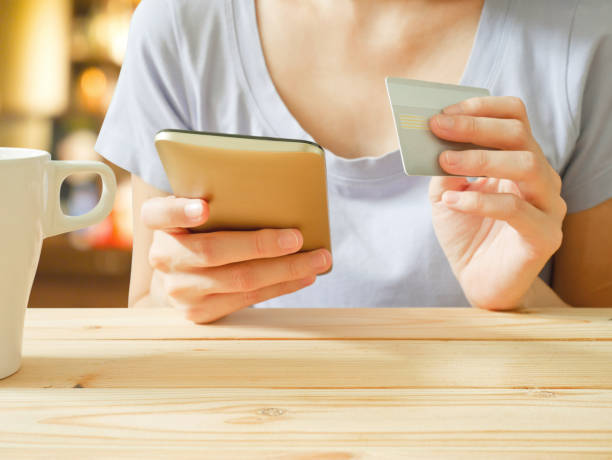 istock Woman using mobile phone shopping online with credit card 834176794