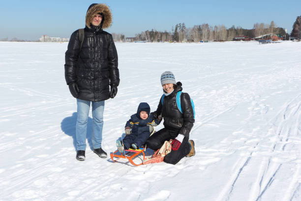 istock Happy family walking on snow in winter 834180410