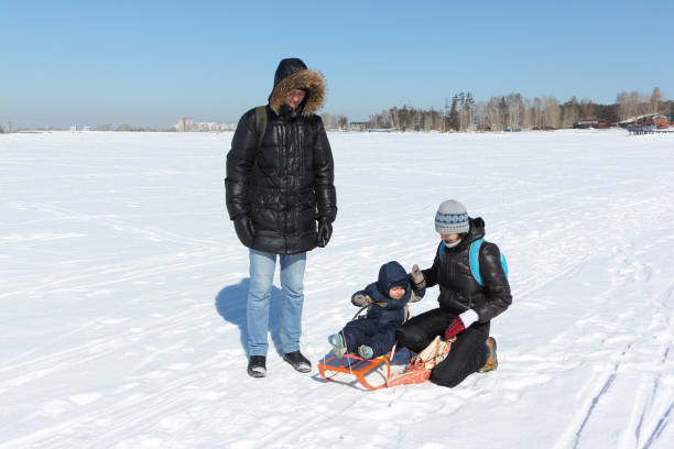 istock Happy family walking on snow in winter 834180418
