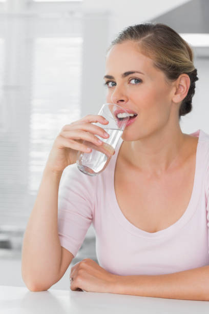 istock Attractive woman drinking water 834203648