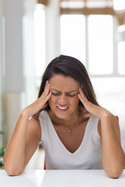 istock Angry young woman rubbing temples 834217498